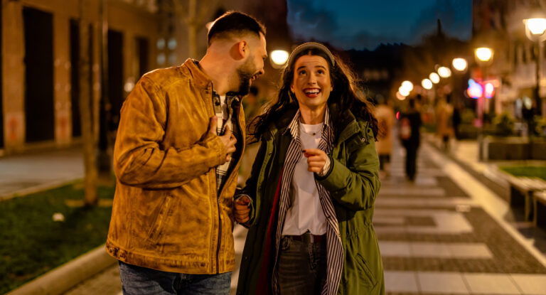 Couple takes a peaceful walk together on a quiet night street